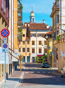 Udine - August 2016, Friuli Venezia Giulia region, Italy: Picturesque view of the old medieval street in historic center of Udine, old colored historical houses and  cars parked near them