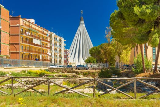 Syracuse - April 2019, Italy: View of The Sanctuary of the Madonna delle Lacrime (Madonna of the Tears) and the ancient Greek architecture ruins in the foreground