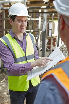 Architect Discussing Plans With Builder