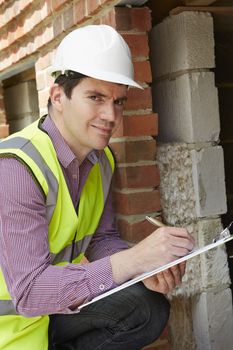 Architect Checking Insulation During House Construction