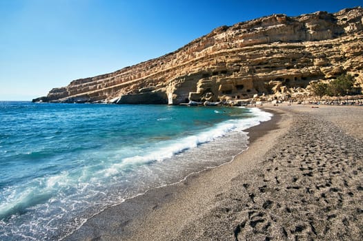 People on the sandy Matala beach on the island of Crete in Greece