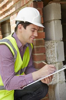 Architect Checking Insulation During Construction Project