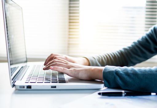 close up hand of accountant pressing and typing keyboard on laptop with free space for text above