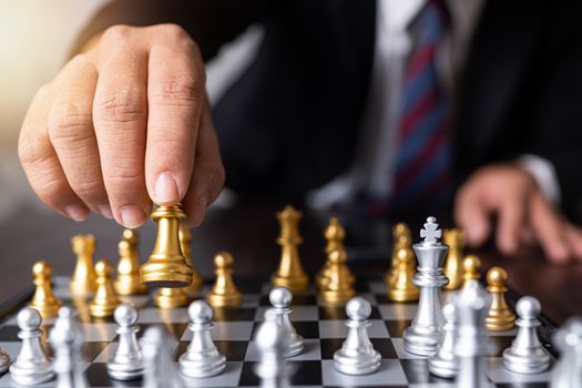 Planning and strategy of successful business competition management concept, businessman moves king of chess