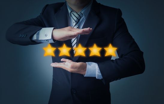 excellent service and best customer experience or good client , business man showing 5 stars rating on dark blue background 