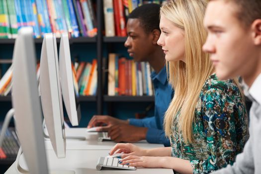 Group Of Teenage Students Working At Computers In Classroom