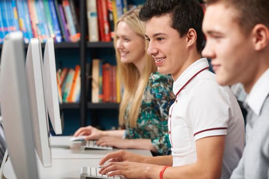 Group Of Teenage Students Working At Computers In Classroom