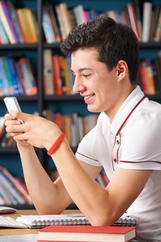 Male Teenage Pupil Texting In Classroom