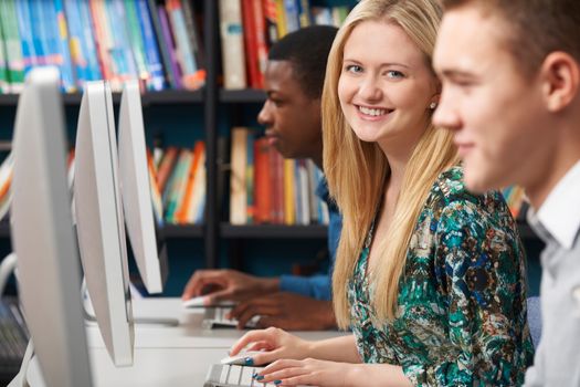 Group Of Teenage Students Working At Computers In Classroom