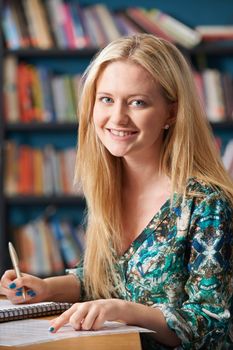 Portrait Of Female Student Working In Library