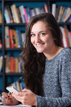 Female Teenage Pupil Texting In Classroom