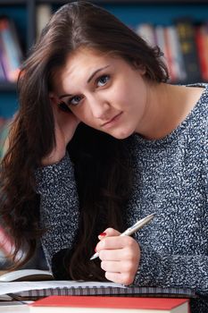 Fed Up Teenage Student In Library