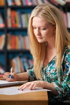 Female Student Studying In Library