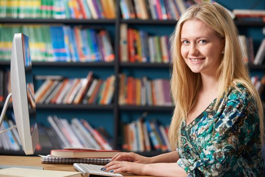 Female Teenage Student Working At Computer In Classroom