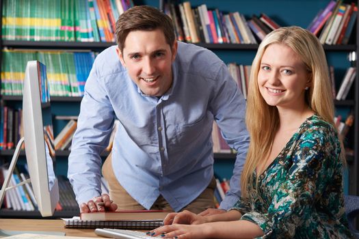 Teacher Working With Teenage Pupil At Computer