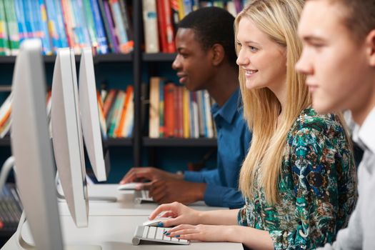 Group Of Students Working At Computers In Classroom