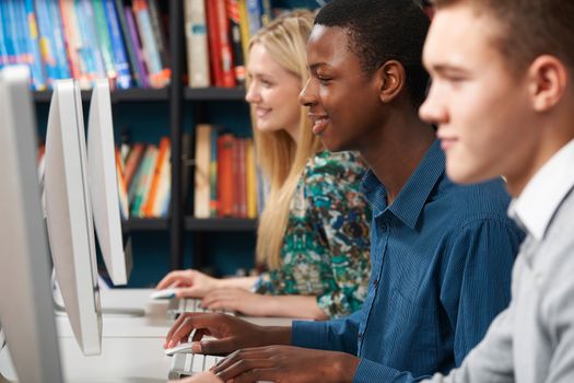 Group Of Students Working At Computers In Classroom