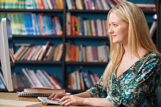 Female Teenage Student Working At Computer In Classroom