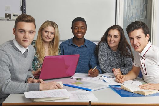 Group Of Teenage Pupils Working In Classroom