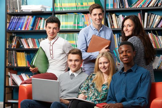 Portrait Of Teacher With Students In Library