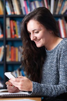 Female Teenage Pupil Texting In Classroom