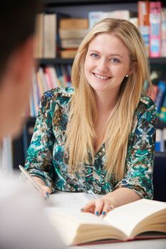 Two Teenage Students Working In Classroom Together