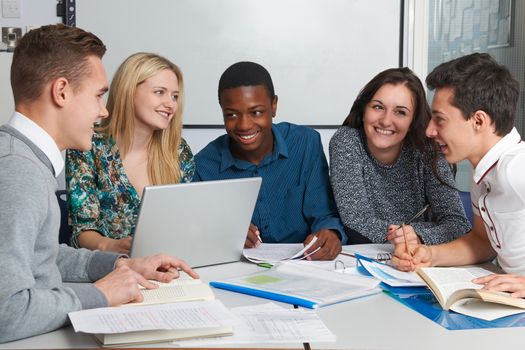 Group Of Teenage Students Working In Classroom