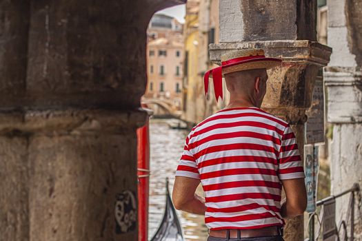 Italian gondolier in Venice, a symbol of tourism in the Italian city of Venice