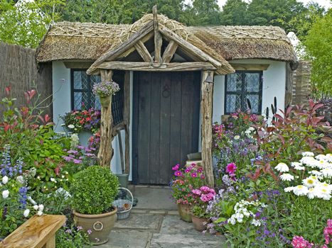 A traditional thatched cottage and garden to creat a calming and relaxing space with colourful flower borders