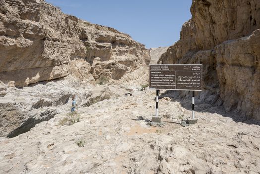 Information board by the ministry of Tourism in the canyon of Wadi Bani Khalid, Sultanate of Oman, Middle East