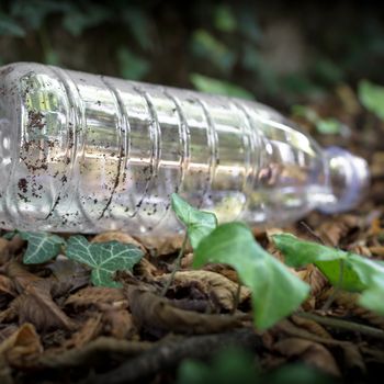 Plastic bottles thrown to the ground. Selective focus. Defocused blurry background.