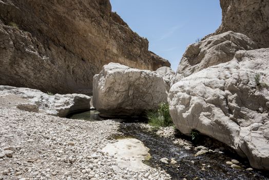 Large stones on the river going thru the canyon of Wadi Bani Khalid, Sultanate of Oman. This is one of the most visited place of the country