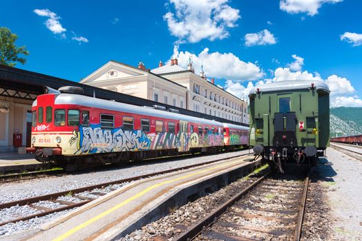 Nova Gorica (Gorizia) - June 2016, Slovenia: View of two trains standing on rails at the old train station in sunny summer day, wide angle perspective