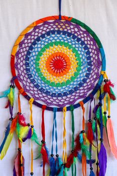 Beautiful multicolored handmade dreamcatcher on white background.