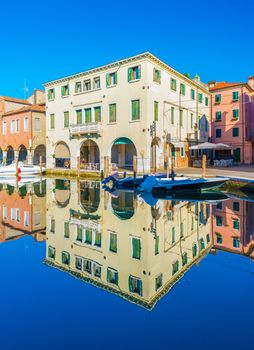 Chioggia - September 2016, Italy: Old buildings in the traditional Venetian architecture style reflected in the water