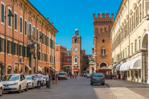 Ferrara - July 2017, Emilia Romagna, Italy: Central street of Ferrara. Taxi cabs and drivers near them. People walking in the historical part of the city