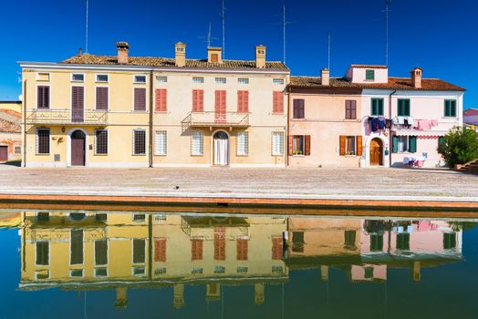 Сomacchio - October 2016, Emilia Romagna, Italy: Colored houses mirror reflected in the water