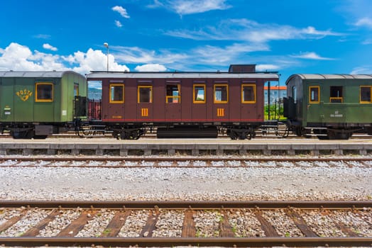 Nova Gorica (Gorizia) - June 2016, Italy: Vintage post-train cars on rails, old train at the station in Slovenian city of Nova Gorica. Sunny summer day