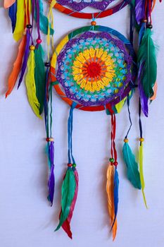 Beautiful multicolored handmade dreamcatcher on white background.