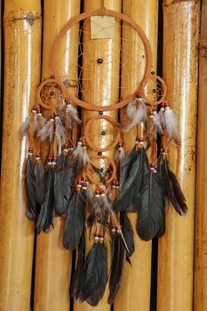 Real native dream catcher on pure natural wooden background.