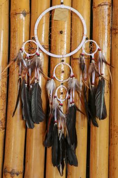 Real native dream catcher on pure natural wooden background.