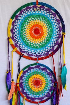 Beautiful multicolored handmade dreamcatcher on white background.