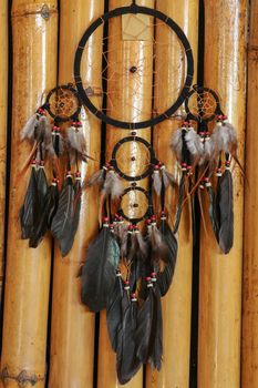 Real native dream catcher on pure natural wooden background.