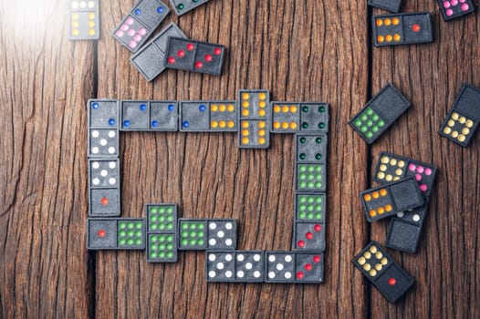 Dominoes. Dominoes is a game played with rectangular "domino" tiles.