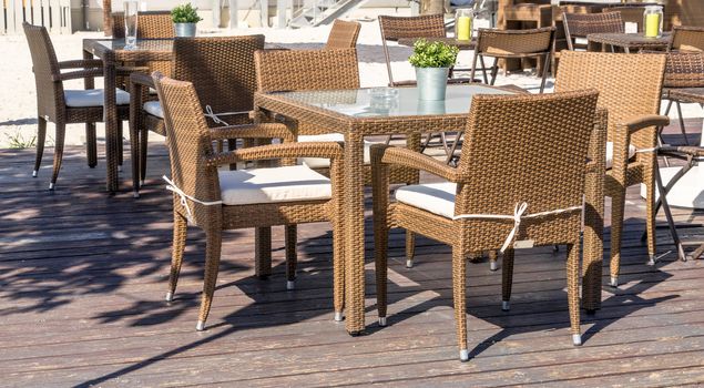 Unoccupied outdoor furniture in the outdoor area of a restaurant is waiting for the customers who eat, drink and smoke here, germany