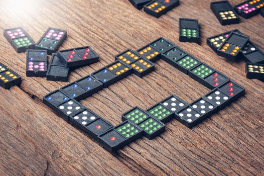 Dominoes. Dominoes is a game played with rectangular "domino" tiles.