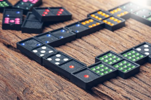 Dominoes. Dominoes is a game played with rectangular "domino" tiles.