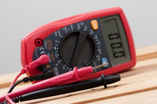 digital multimeter or multitester or Volt-Ohm meter (closeup at test leads), an electronic measuring instrument that combines several measurement functions in one unit.