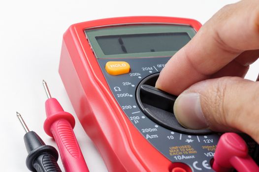 electrician switching the selector of multimeter