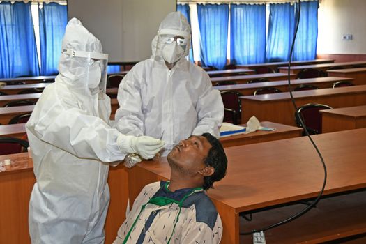 Burdwan Town, Purba Bardhaman District, West Bengal / India - 24.06.2020: Health workers are collecting samples of asymptomatic journalist for COVID-19 (Novel Coronavirus) test in the initiative of Purba Bardhaman District Health Department.